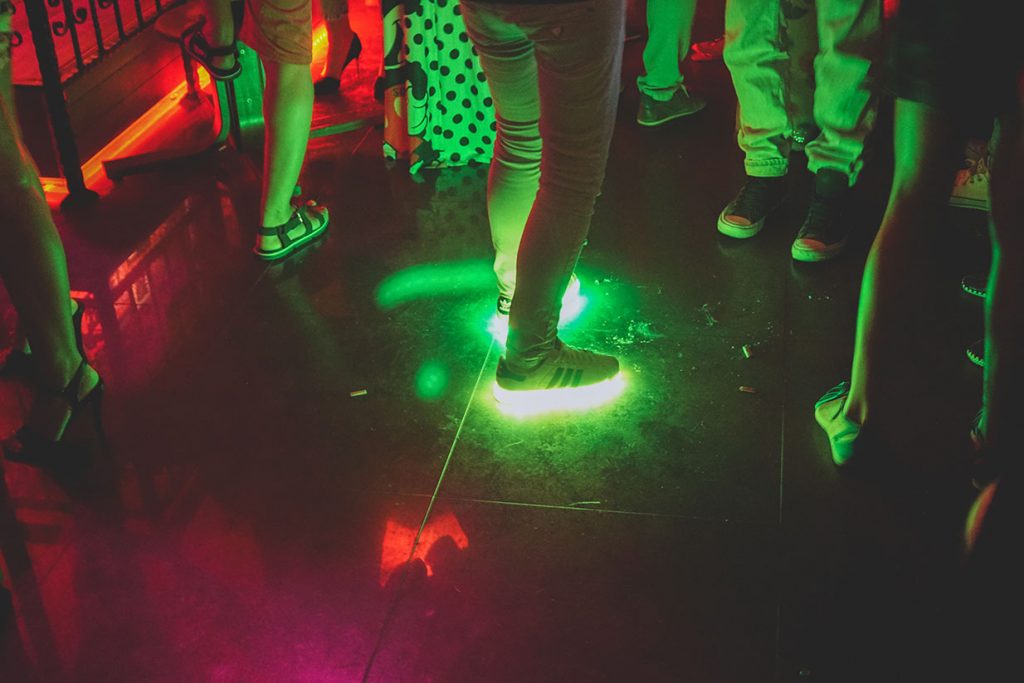 Sneakers with lights in them at a disco