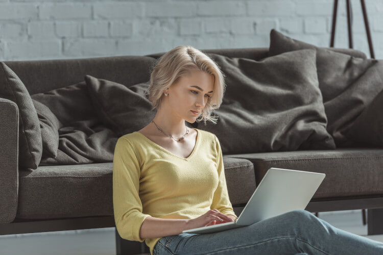 Young woman using a laptop in her home