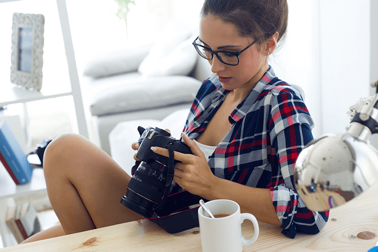 A staged scene of a photographer and her camera