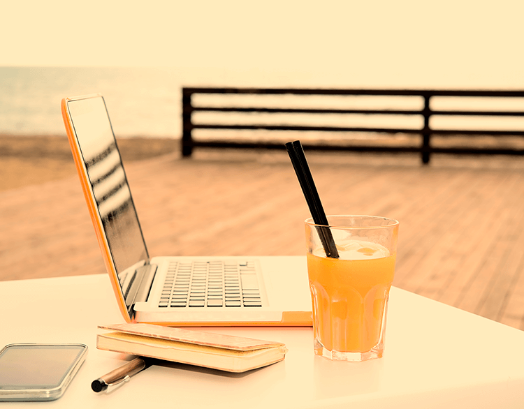 Laptop and a drink on the pier