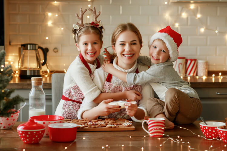 happy family mother and children bake Christmas cookies