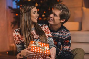 Young Couple Exchanging Gifts at Christmas